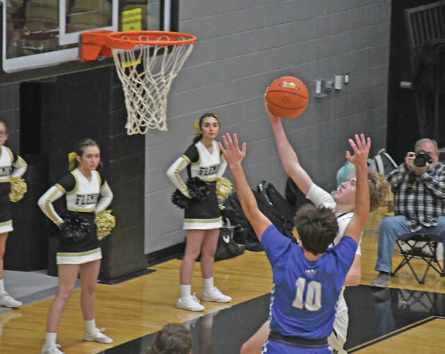<p>Fleming County’s Seth Hickerson goes up for a layup over Mason County’s Mason Butler, Friday, in Flemingsburg. (Evan Dennison, The Ledger Independent)</p>