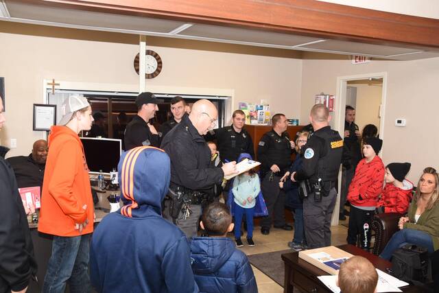 127985274_web1_makingalist
Assistant Maysville Police Chief Major Mike Palmer checks his list before heading out for the Christmas with a Cop event Tuesday at the Maysville Walmart. The annual event is sponsored by FOP Limestone Lodge No. 5 Maysville. Agencies involved in the event included Maysville Police Department, Mason County Sheriffs Department, Flemingsburg Police Department, Augusta Police Department and Bracken County Coroner Office.