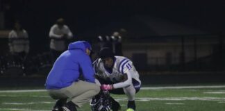 
			
				                                Mason County senior Khristian Walton is consoled by a coach after the Royals fell to Bardstown 38-28 in Friday’s Class 3A semifinal game at Garnis Martin Field. (Josh Claywell)
 
			
		